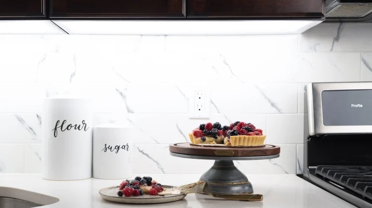 Kitchen counter with berry tart, Flour and sugar canisters on counter